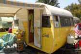 Sharp vintage Shasta Travel Trailer painted bright yellow and white